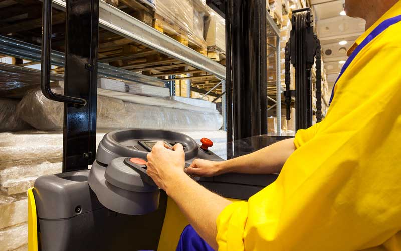 AW Associates LLP Fork lift driver in hi vis clothing