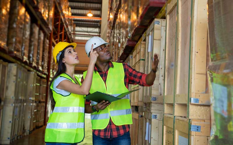 AW Associates LLP Warehouse workers in hi vis jackets and hard hats